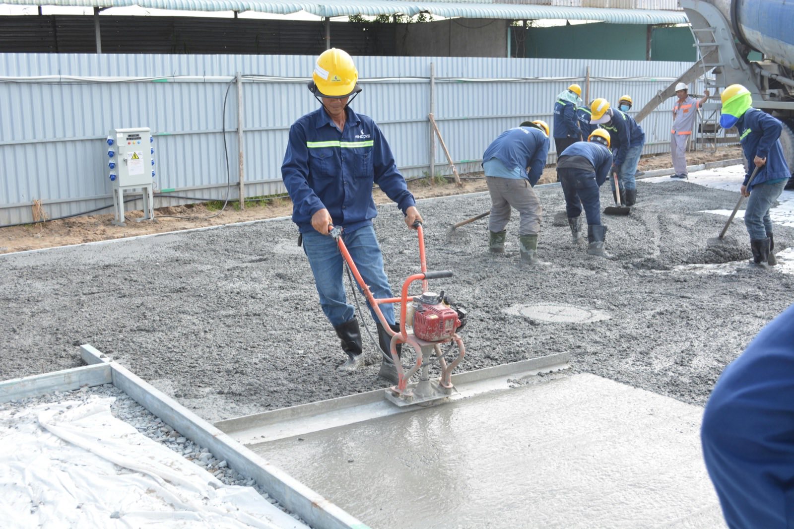 Concrete crew finishing a pour on site