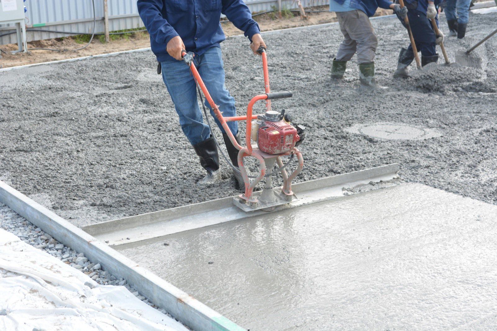 Concreter using finishing equipment on site